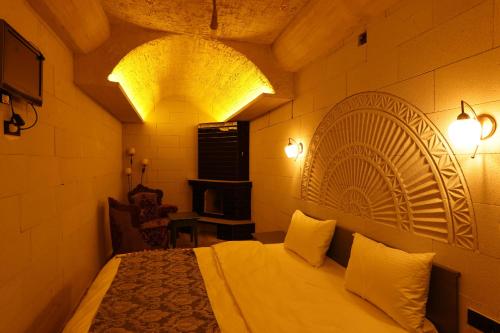 a bedroom with a bed in a room with lights at Ashab-I Kehf Cappadocia House in Nevsehir