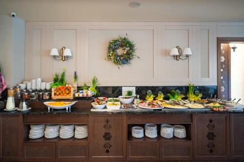 a buffet with many plates of food on it at Hotel Tatra in Zakopane