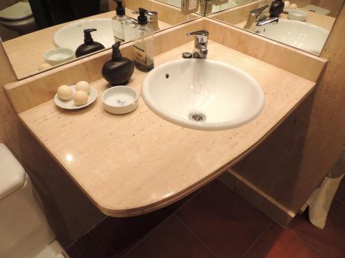 un bancone del bagno con lavandino e specchio di Apartamento en Comillas_Rovacias guest house a Comillas