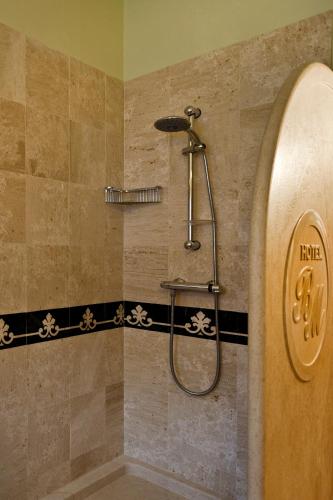 a shower in a bathroom with a shower head at Hotel Brancamaria in Cala Gonone