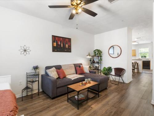a living room with a couch and a ceiling fan at Convenient & Inviting - Fully-Equipped 2BD Condo in Gainesville