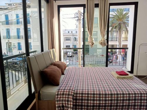 a bedroom with a bed with a checkered table cloth at Victoria in La Marsa