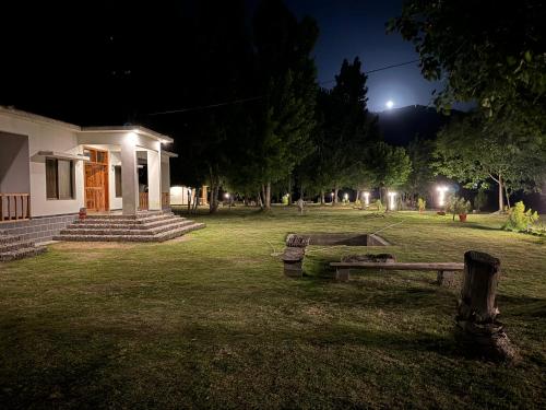 a group of benches in a yard at night at Two-Bedrooms Suite At Country Club Balakot in Bālākot