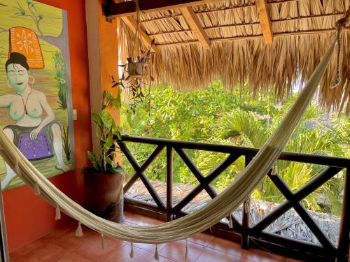 a hammock in a room with a window at Hotel Casa Mixteca in Zipolite
