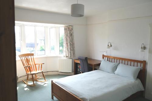 a bedroom with a bed and a desk and a chair at Lynton Road in London