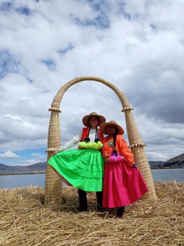 two people are standing under an arch in hay at Q'OTA TAYPY LODGE in Puno