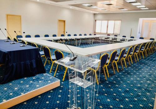 a conference room with a long table and chairs at Hotel Fieri in Fier