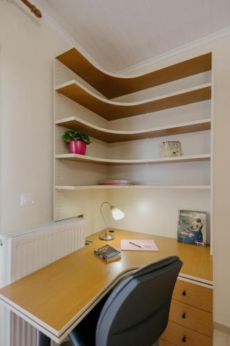 an office with a wooden desk and a chair at Catherine's View in Agios Rokkos