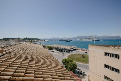 a view of the roof of a building and the water at Catherine's View in Agios Rokkos