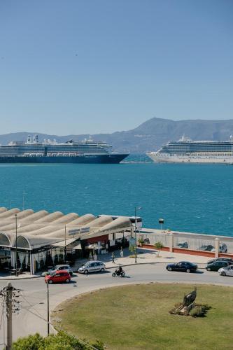 a large cruise ship in the water with a parking lot at Catherine's View in Agios Rokkos