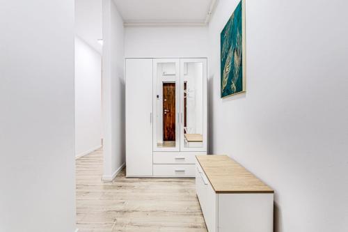 a white room with a white door and a table at ARI GREEN Apartment near Atrium Mall in Arad