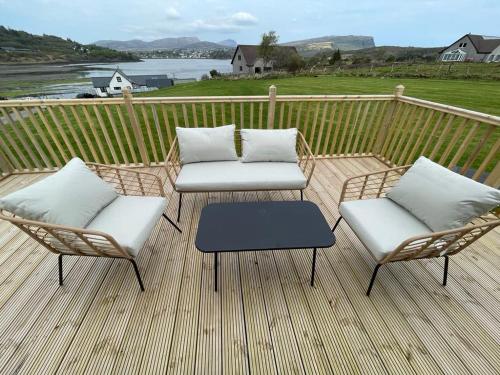 two chairs and a table on a deck at STORR (caravan skye holidays) in Portree