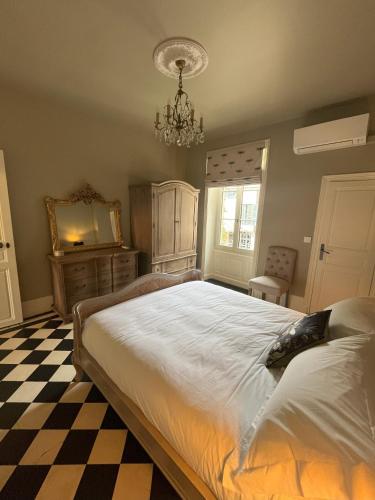 a bedroom with a bed and a checkered floor at Number 8 in Meursault
