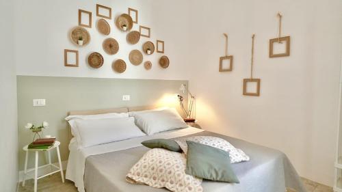 a bedroom with a white bed with pillows on it at Nel Borgo di San Francesco - Casa vacanze in centro in Villa Santa Maria