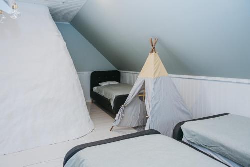 a room with two beds and a tent at Wiigi Family Home & Spa in Haapsalu