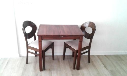 a wooden table with two chairs and a wooden table at Тут светло и уютно in Kyiv