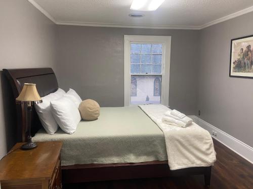 a bedroom with a bed with two pillows and a window at Best value 4 Huge Bedrooms in Willmar