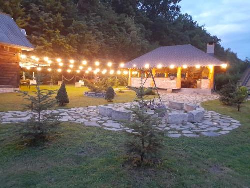 a pavilion with lights in a yard at night at Căsuțe A-Frame Hardic in Horodnic de Sus