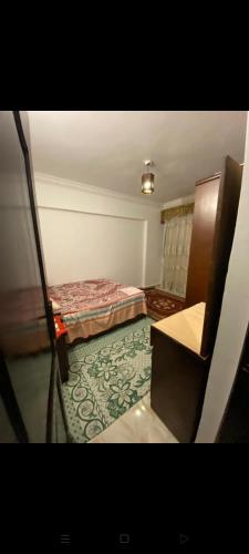 a small room with two beds and a rug at اسكندريه in Alexandria