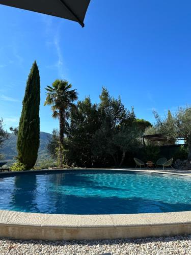 a swimming pool in front of a house at Cà di Mora in Lisciano Niccone