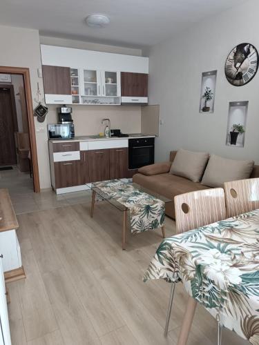 a living room with a couch and a table at Megi Luxury Apartments in Pomorie