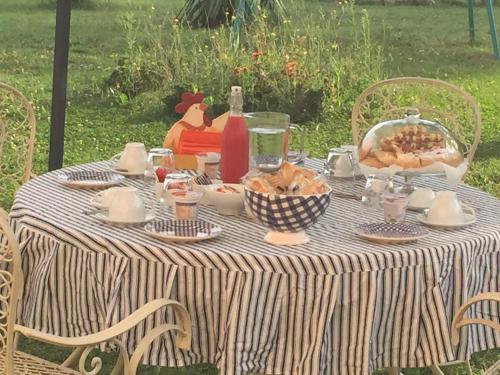 a table with a striped table cloth with food on it at B&B Country Dreams in Sulmona