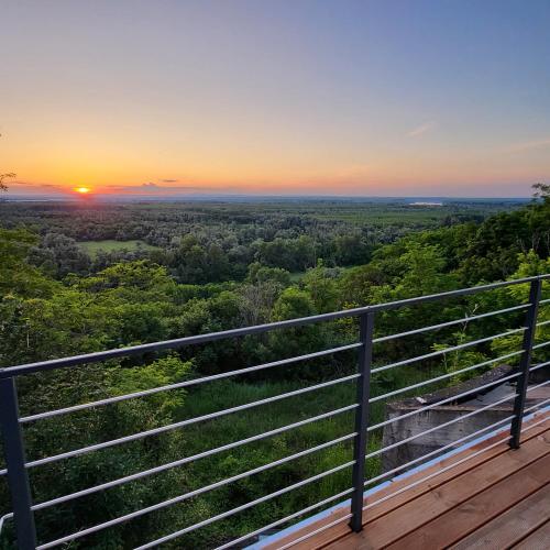 a view of the sunset from the top of a wooden deck at La Vida Panorama in Batina