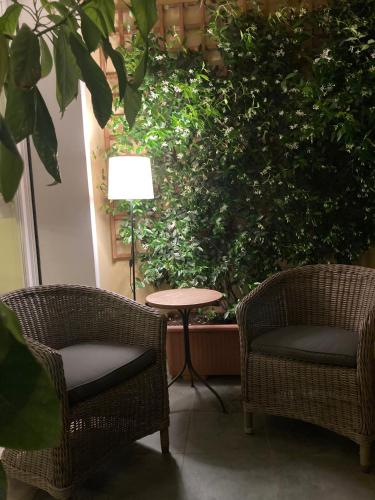two chairs and a table and a lamp on a patio at Coloniola Lake House in Como