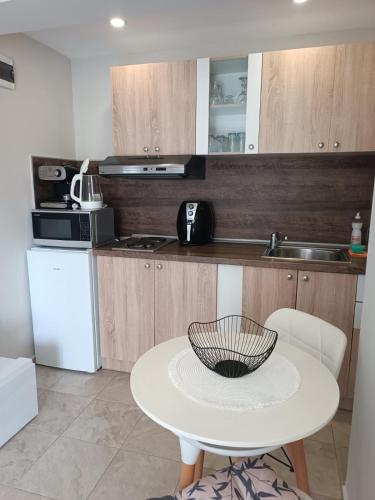 a kitchen with a table with a bowl on it at Megi Apartments, Nesebar sity in Nesebar
