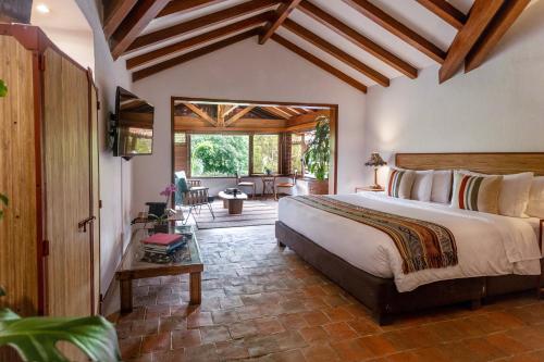 a bedroom with a large bed in a room at Sazagua Hotel Boutique in Pereira