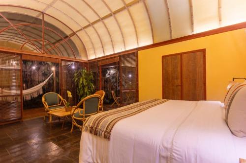 a bedroom with a bed and a table and chairs at Sazagua Hotel Boutique in Pereira