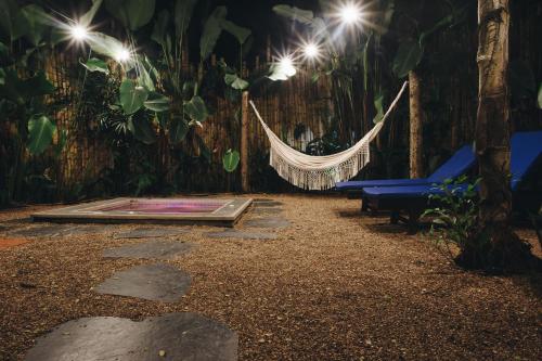 a hammock in a garden at night with lights at Sazagua Hotel Boutique in Pereira