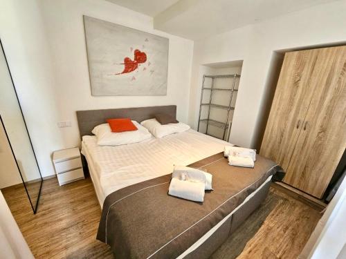 a small bedroom with a bed and a mirror at BeeFree WhirlpoolSuite34-Free Parking & Fast Internet in Passau