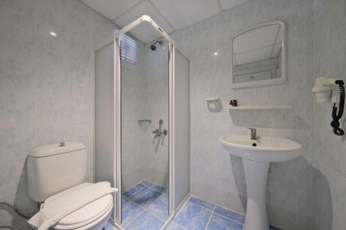 a bathroom with a toilet and a sink and a shower at Majestic Hotel in Oludeniz