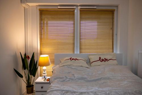 a bedroom with a white bed with a window at Imperial Citi Yes Apartament in Krakow