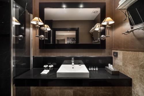 a bathroom with a sink and a mirror at Hotel B Berdichevsky in Tel Aviv