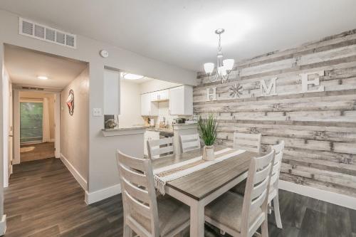 a kitchen and dining room with a reclaimed wood wall at Cozy 2BR Farmhouse Apt - Sleeps 8 - FREE Parking! in Arlington