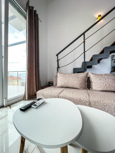 a white room with a bed and a white table at LOUTRA VILLAS in Agia Paraskevi