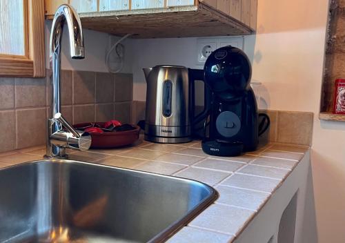 a kitchen counter with a sink and a mixer at Quinta Dormmimo a Hidden Gem with Pool near Tomar in Fonte da Laje