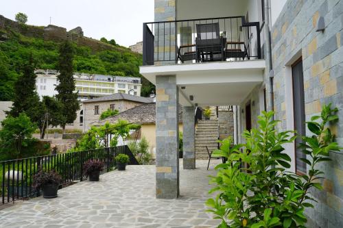 a balcony with a chair on top of a building at Castlefront Villa in Gjirokastër
