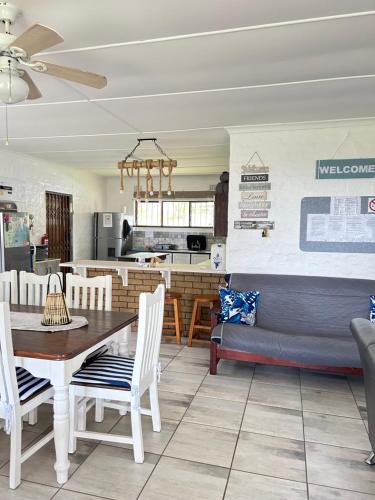 a dining room and kitchen with a table and chairs at Meet U at the Beach in Hibberdene