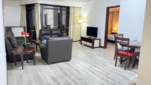 a hotel room with a living and dining room at 100 Service suites At Times Square KL in Kuala Lumpur