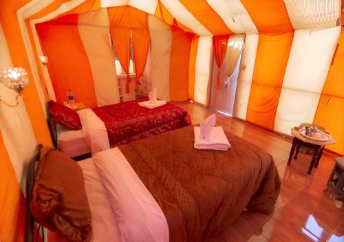 a bedroom with two beds in a tent at Merzouga Lovely Luxury Camp in Merzouga