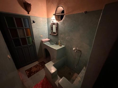 an overhead view of a bathroom with a sink and a shower at La Maison Haute Larache Morocco in Larache