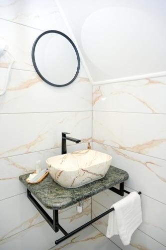 a bathroom with a sink and a mirror at Cottage NIKA in Jajce