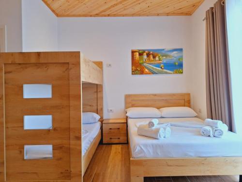 a bedroom with two beds and a bunk bed at Xuxi Apartments in Lukovë