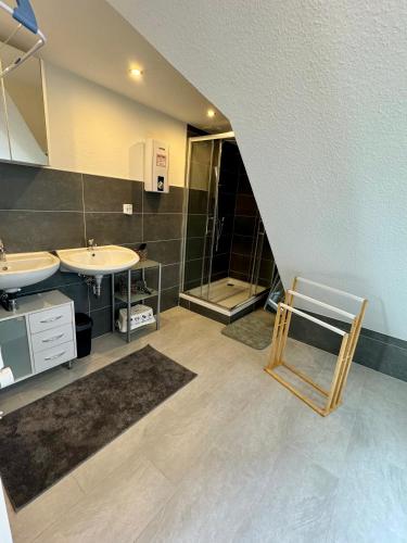 a large bathroom with two sinks and a shower at Ferienhaus Auszeit in Medebach