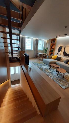 a living room with a staircase leading to a living room at Casa das Flores in Bragança