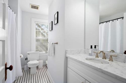 a white bathroom with a sink and a toilet at 388 Main Street Chatham Cape Cod - - The Priscilla House in Chatham