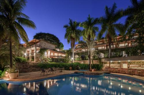 an exterior view of a resort with a swimming pool at Hotel Canto das Águas - Roteiro de Charme in Lençóis
